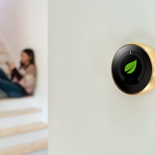 Photo of a smart thermostat on a wall in a modern home.