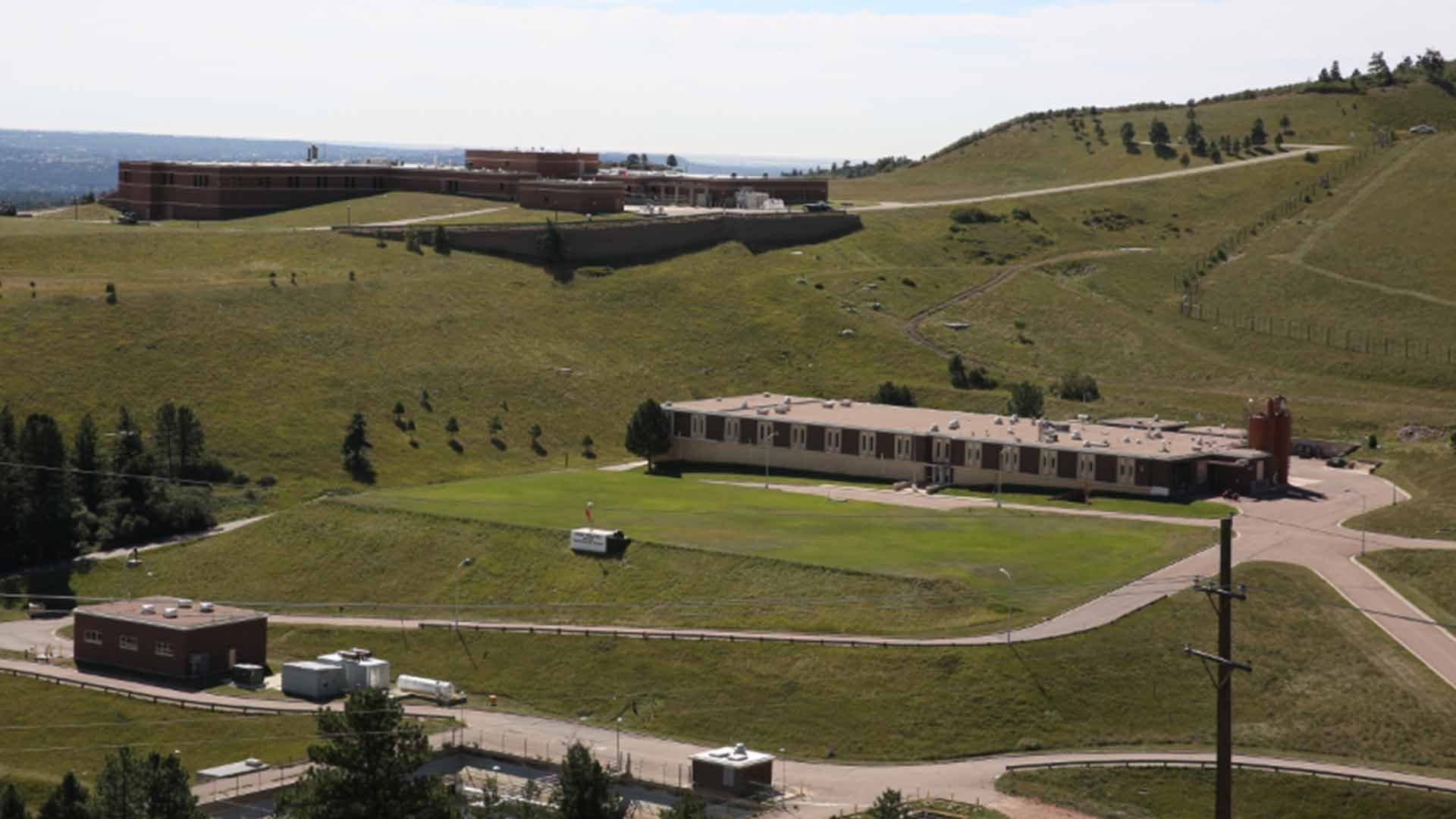 McCullough Water Treatment Plant, a single story tan brick building, on a grassy hillside.