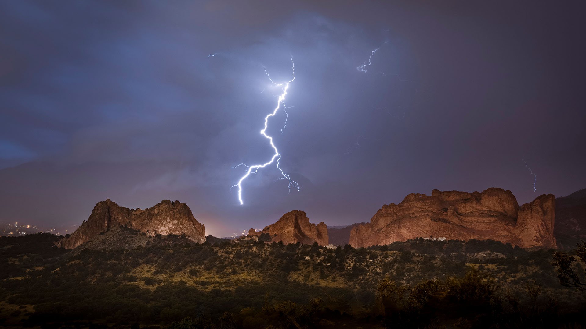 Lightning bolt photographed over Garden of the Gods at night.