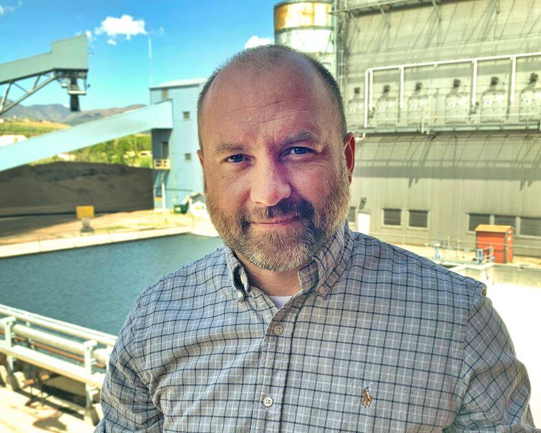 Engineering Supervisor Nick Miller in front of the Martin Drake Power Plant. Miller received the RMEL 2021 Emerging Leader Award in June 2021.