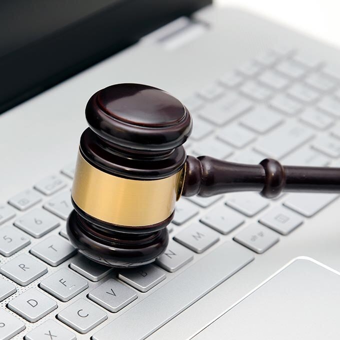 Wooden gavel on a laptop computer.